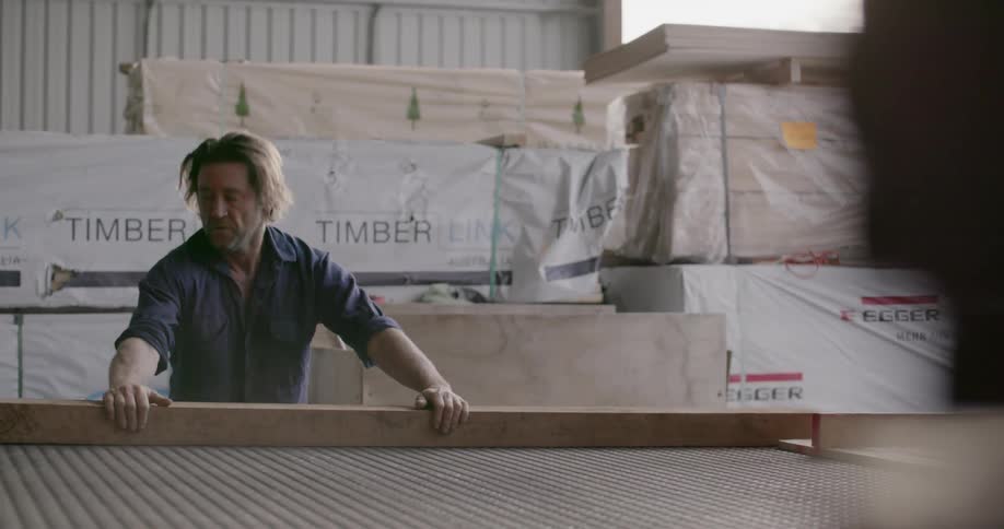 Man loads lumber at a warehouse