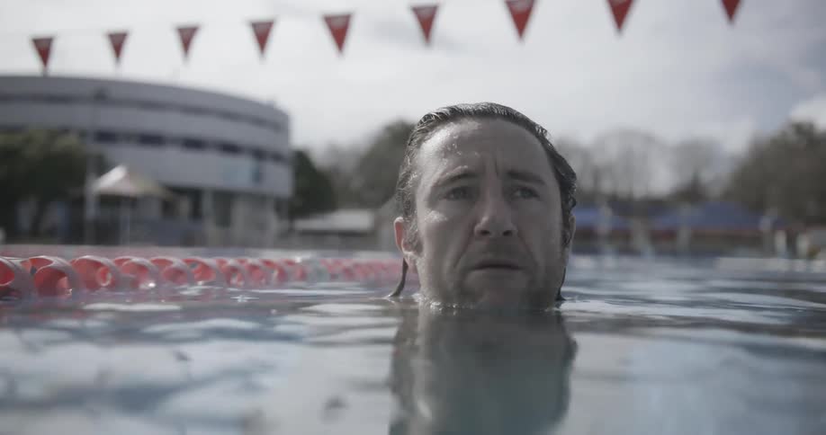 Man swims in an outdoor pool
