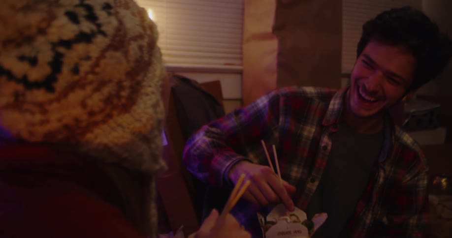 A man and woman eat chinese food together