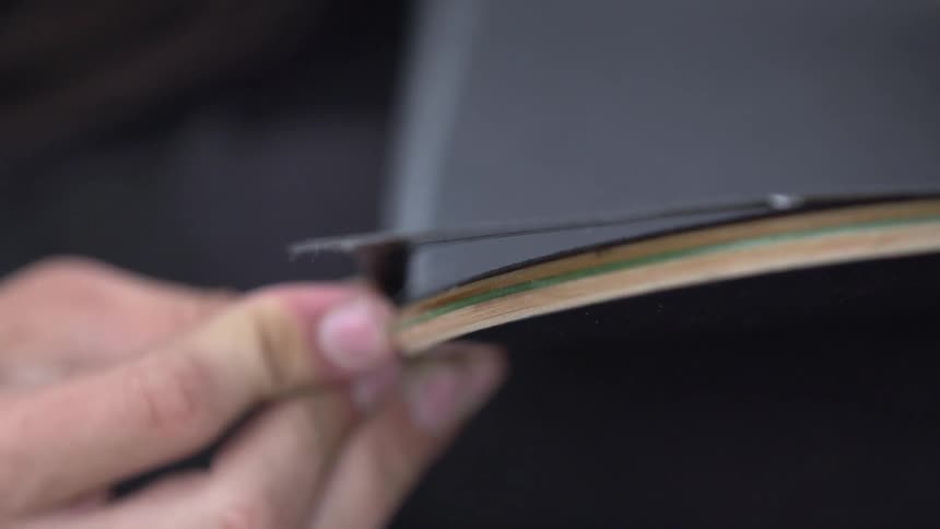 A person running their fingers along wood