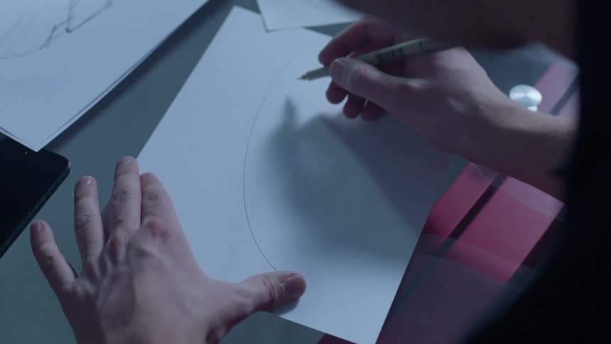 Man draws o a piece of paper