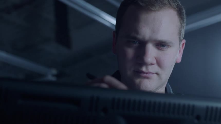 Man looks at a computer monitor and draws on the screen
