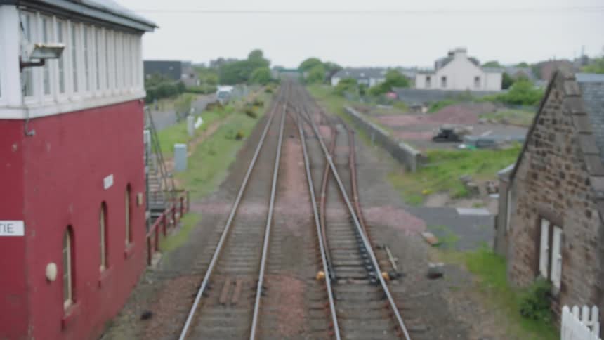 Train tracks extend past an old depot