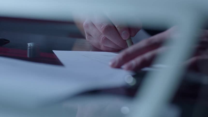 Person draws something on a piece of paper