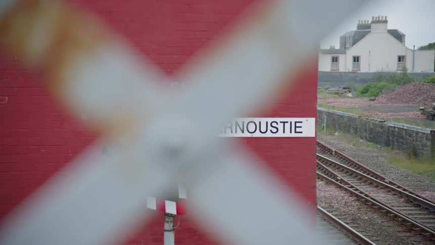 A railroad track runs through a rural town