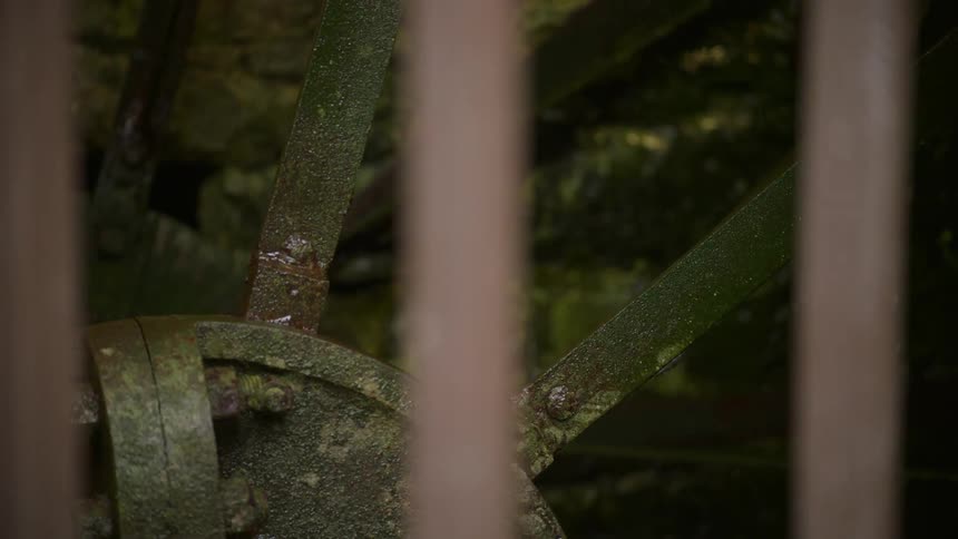A water wheel turns and spills water