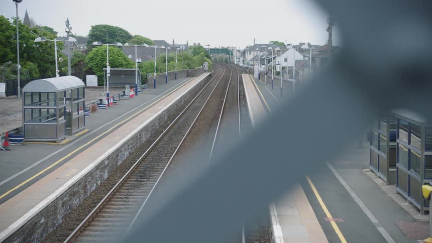 A sign is displayed at an empty railway station