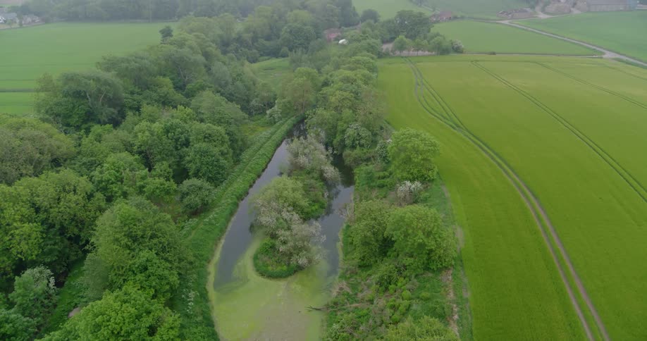 A river runs next to rural fields