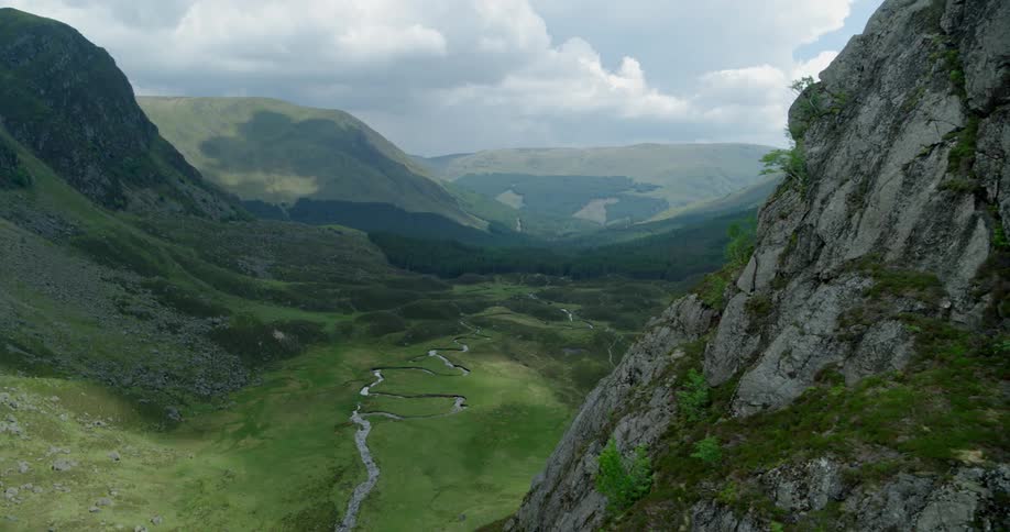 Dark clouds hang above the mountain valley