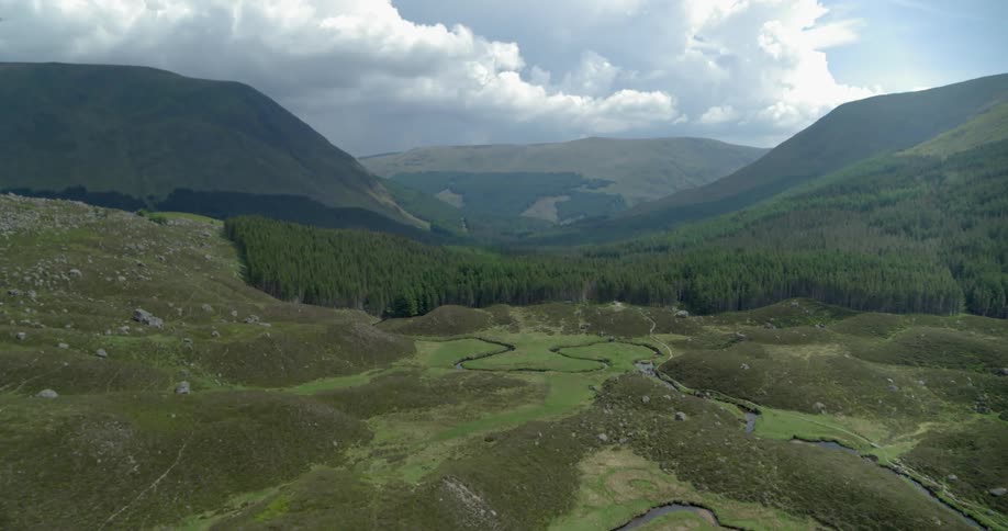 Clouds float above a mountain valley