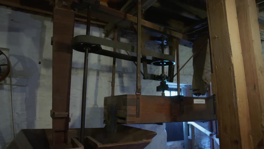 Wood machinery turns and spins in a dark room