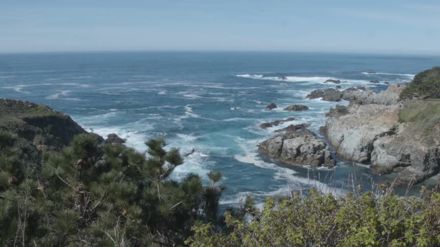 The tide flows onto the rocky shore