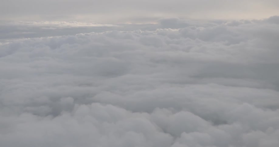 Flying above white clouds on a bright day