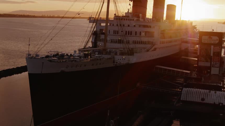 A large freighter boat sits docked in the water