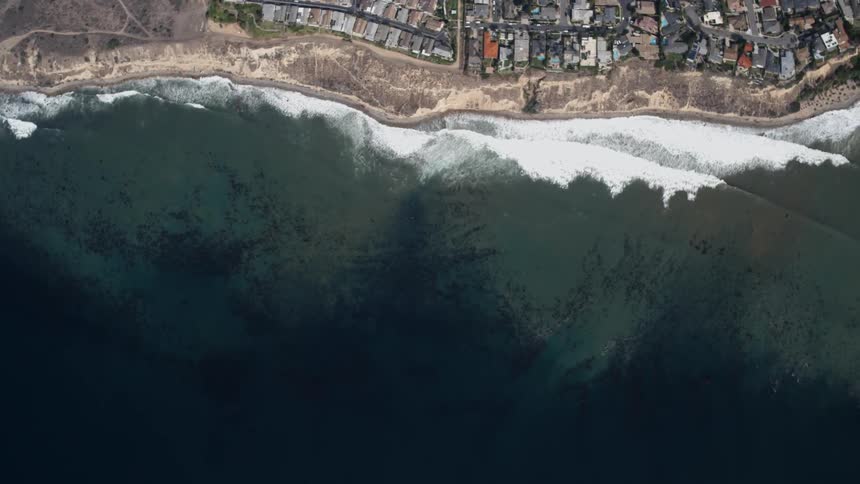 Ocean waves crash into the shoreline