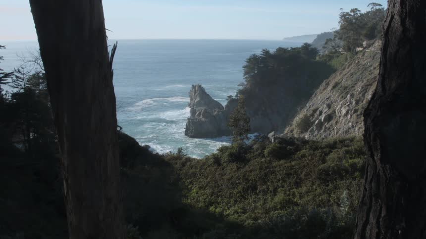 The tide flows towards the rocky shore