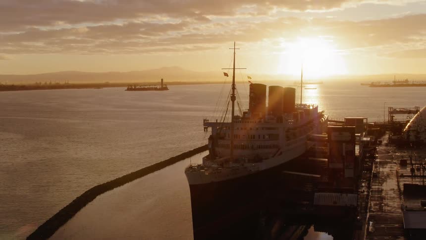 A large freighter boat sits docked in the water