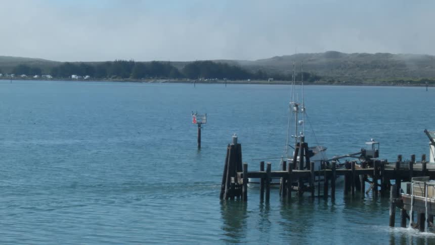 A boat travels along the pier