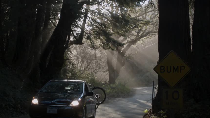 Vehicles travel on a narrow mountain road