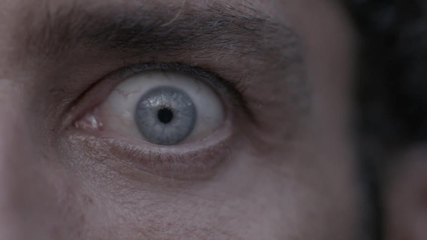 A man is opening his eyes wide