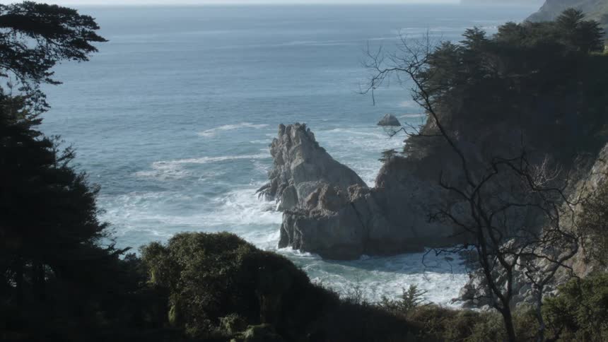 Ocean waves crash into a rocky shoreline