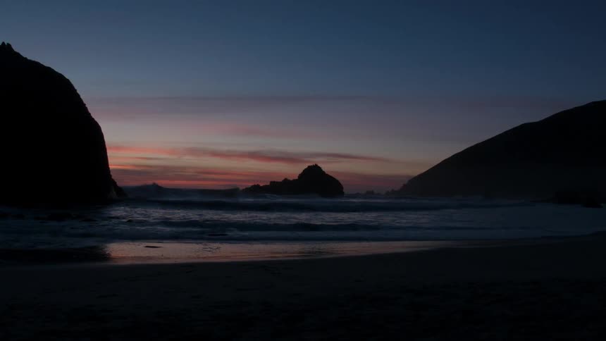 Ocean waves wash ashore at sunset
