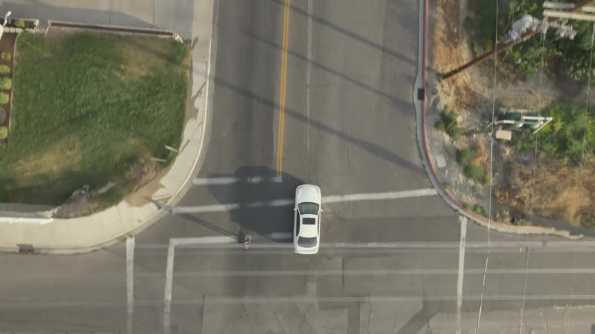 Aerial view of a person skateboarding downhill on a street