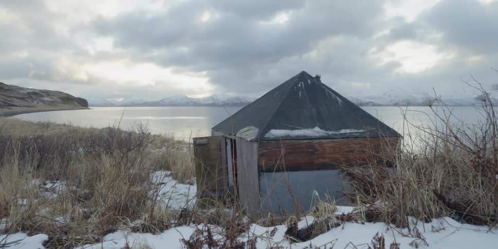 A wooden shack sitting next to the sea