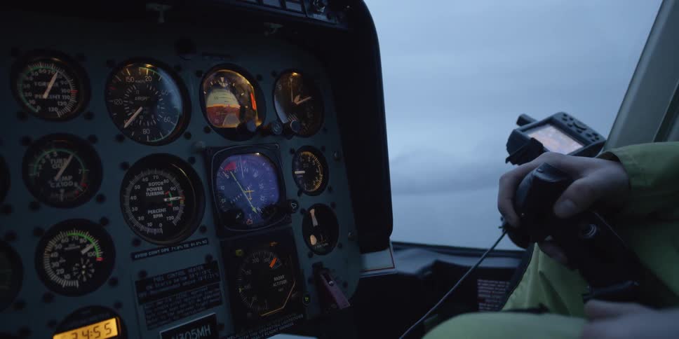 A person pilots a helicopter
