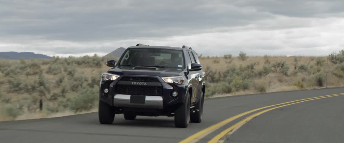 A man drives a truck on a rural road