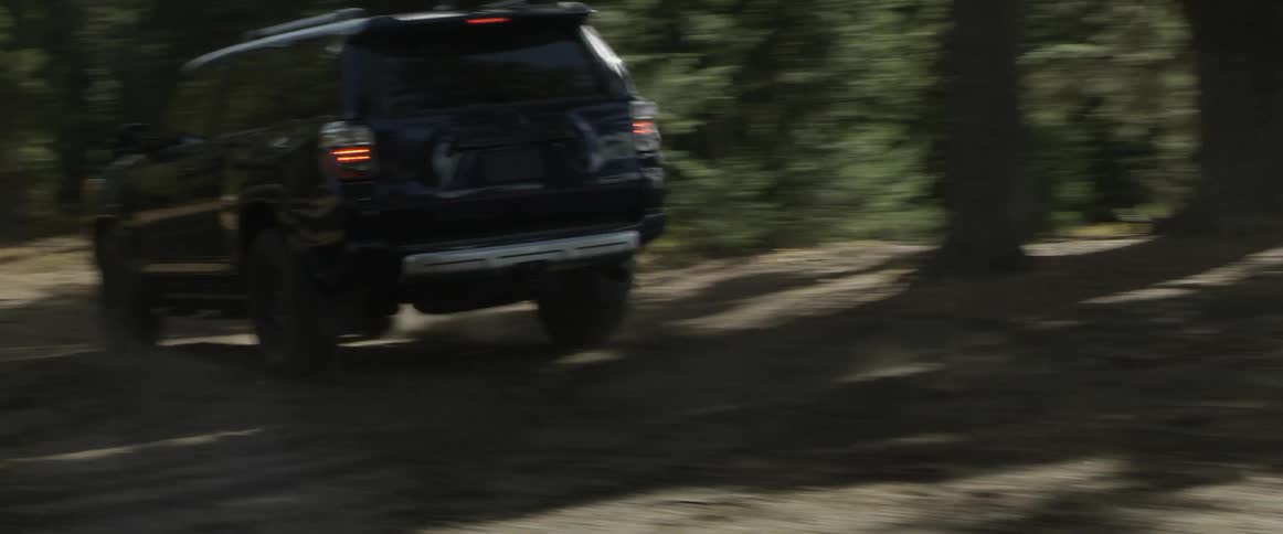 An suv travels along a bumpy dirt road