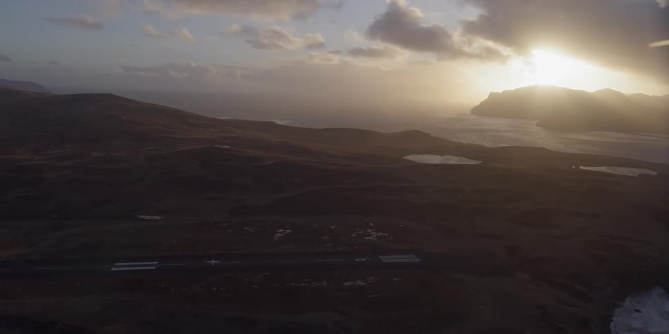 The sun light shines onto the airport and shore