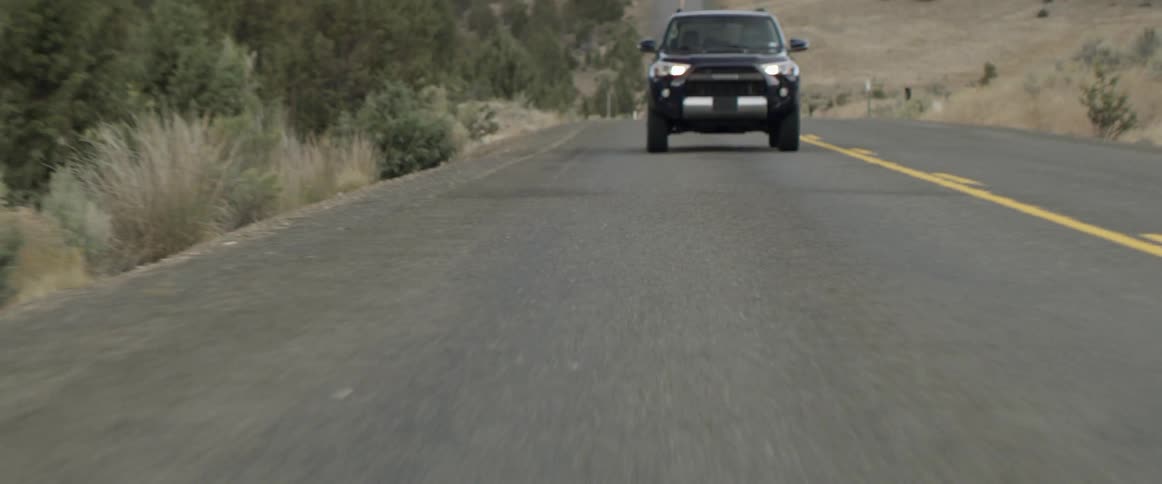 A jeep is traveling down the highway