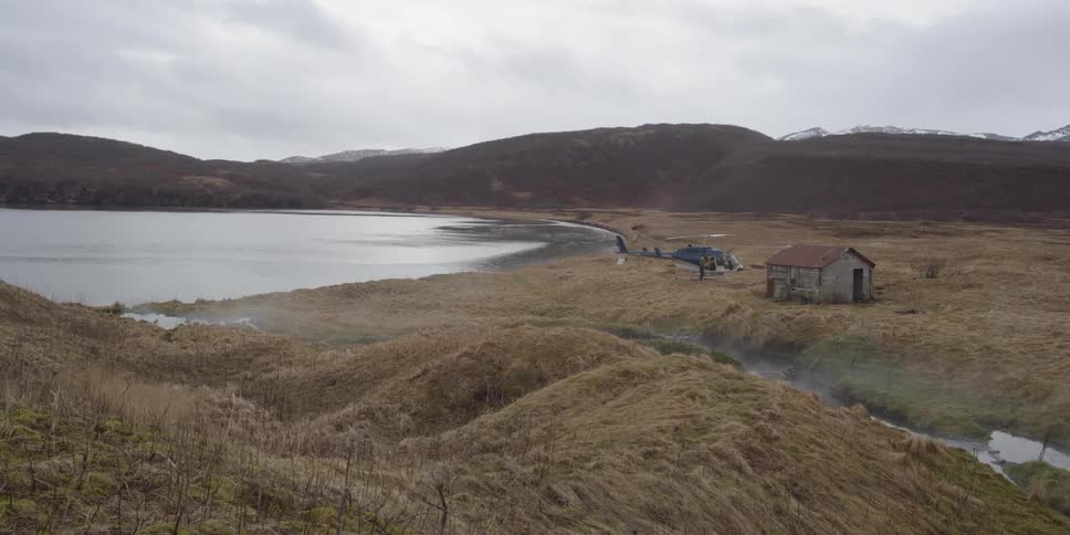 A helicopter and shack by the shore