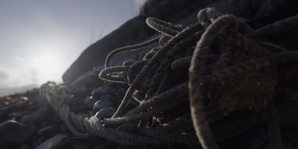 Rope is tangled and lying on the rocks on a sunny day