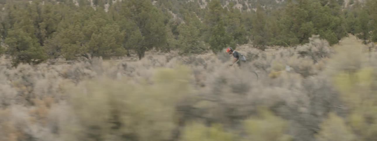 Someone is riding a bike down a dirt trail