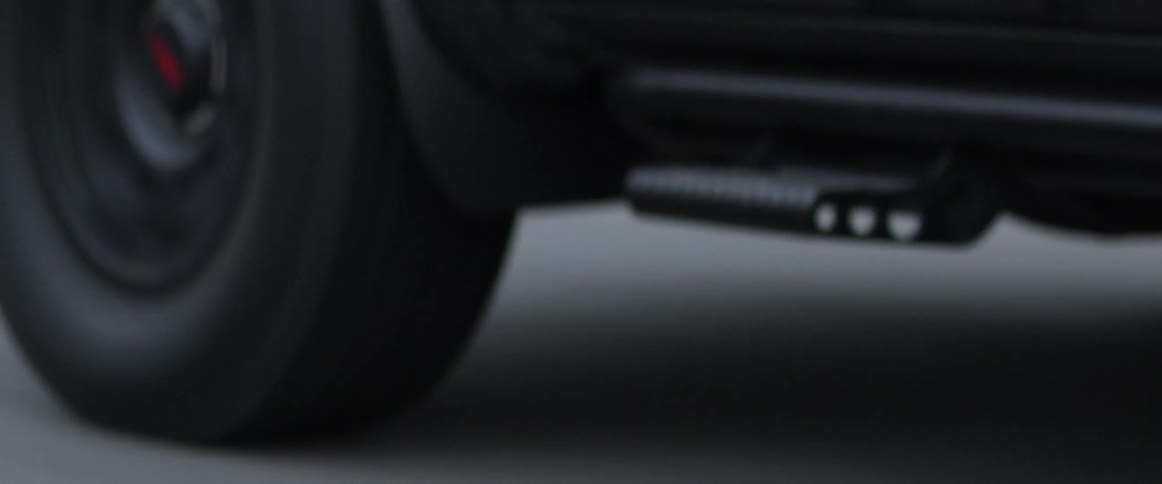 A vehicle drives on a paved road