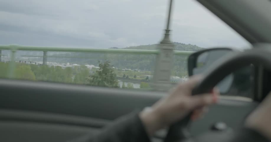 Person driving a car on a cloudy day