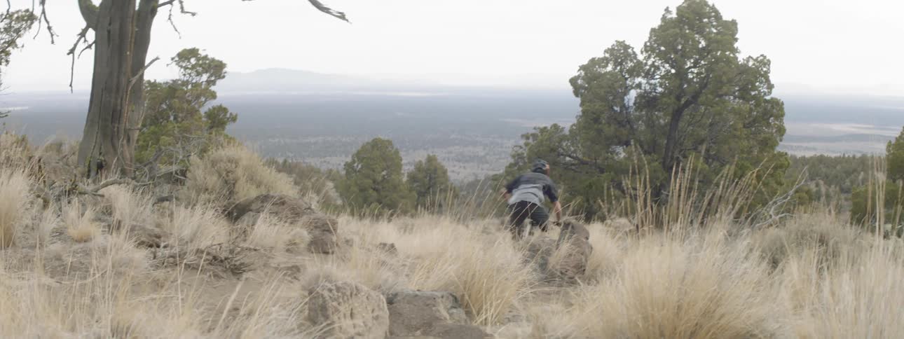 A man races his mountain bike downhill
