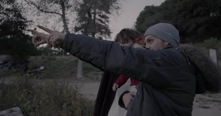 A family look out and point over a field
