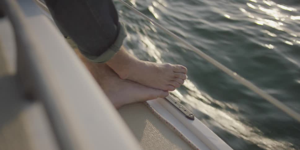 Persons feet as they stand on a moving boat