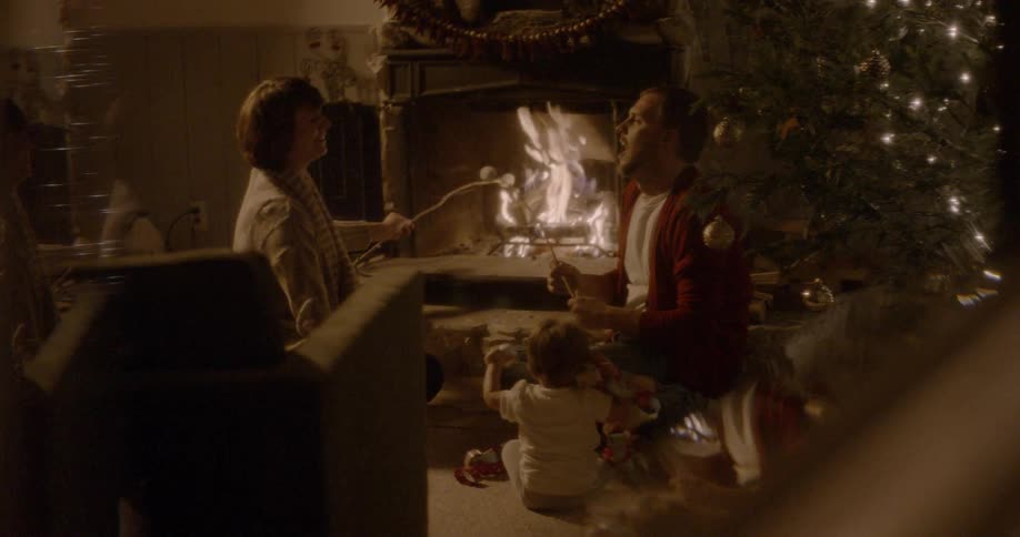 A family roasts marshmallows inside at christmastime
