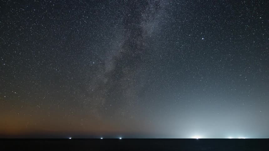 Time lapse of the starry night sky and milky way at sea