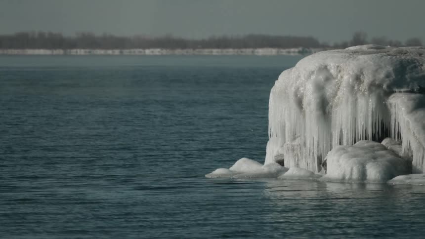 Ice protrudes from a body of water