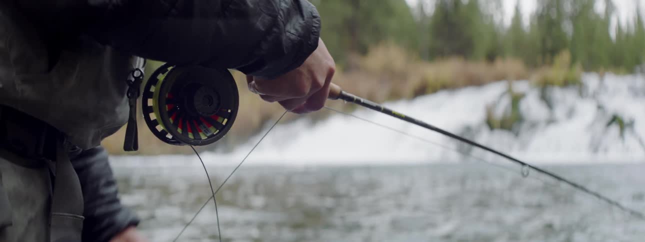 A man fishes in a forest river