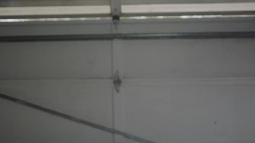 Walks away and a garage door closes behind him