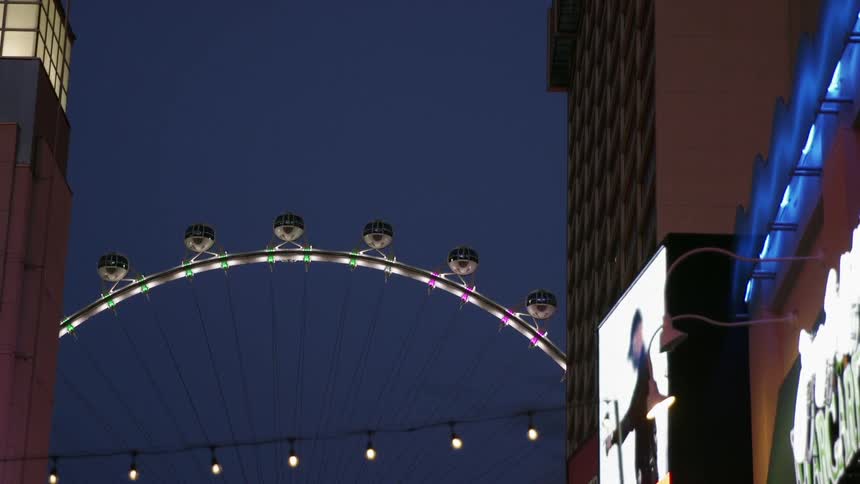 A large ferris wheel in the middle of a city street
