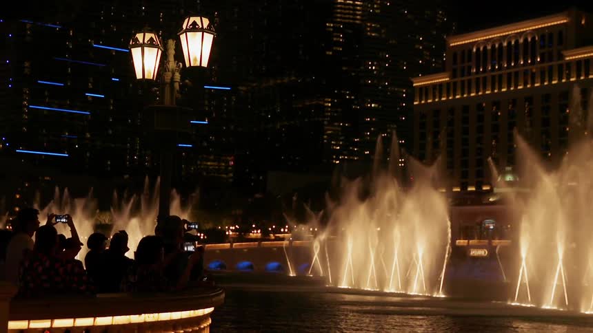 The fountains are lit and spraying at night
