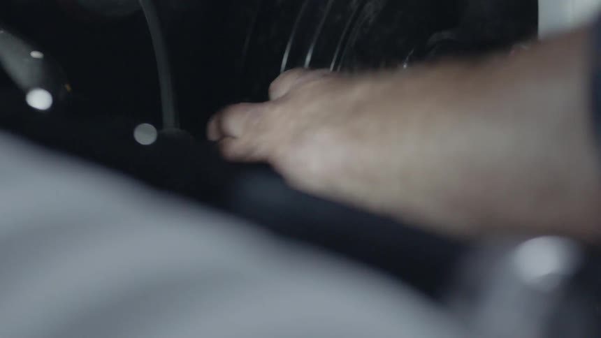 A man's hand as he works on an engine