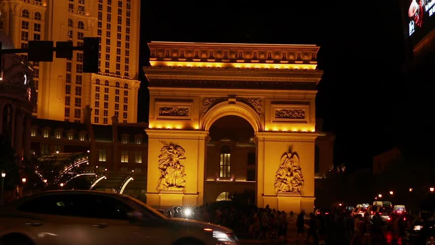 Cars drive on a city street at night